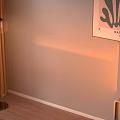 Wall Mounted Clothes Rack With Children's Clothes Shoes Slippers And Light Colored Wall