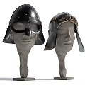 Antique Medieval Helmets With Ornate Metal Designs Displayed On Head Mannequins