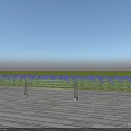 Metal Fence on Wooden Platform with Blue Flower Field and Clear Blue Sky