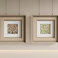 Two Beige Square Picture Frames With Floral Prints Hanging On Wall