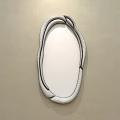 Wall Mounted Wooden Frame Mirror With Irregular Shape Reflecting Sofa And Wooden Floor