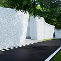 Perforated White Feature Wall In South Fountain Garden With Greenery And People Walking