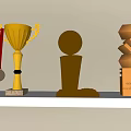 Gold Copper Trophies and Medals with Red Ribbon Spherical and Geometric Design on Shelf