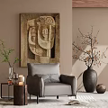 Cozy Gray Accent Chair with Throw Pillow Near Abstract Painting and Decorative Vase