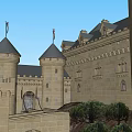 Ancient Castle Architecture With Towered Spires Perched On Hill Surrounded By Trees And Water