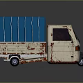 Old Cream White Tricycle Truck With Blue Canvas Cover And Rusty Body