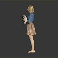 Woman in Blue Blouse and Floral Skirt Holding Small Dog Barefoot on Gray Background