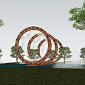 Golden Concentric Ring Sculpture with Inscriptions Surrounded by Trees and Water