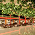 Large Indoor Arbor With Green Leaves Yellow Fruits Red Pillars Long Tables In Dining Space