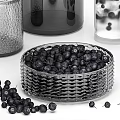 Glass Vases and Decorative Jars with Black Berries in Woven Basket and Pitcher