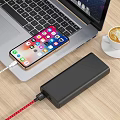 Modern Digital Workspace With Charging Smartphone Power Bank And Laptop On Wooden Desk