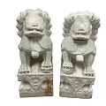 Pair Of Traditional Stone Lion Sculptures With Intricate Carved Details And Ornate Base
