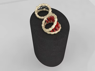 Two Elegant Gold Rings With Red And Black Twisted Design On Black Display Stand 3d model