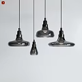 Modern Glass Pendant Lights in Various Sizes Hanging Against White Background