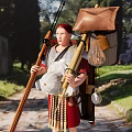 Game Movie Character Roman Soldier Wearing Armor Red Tunic with Spear Near Ancient Ruins