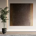 Large Textured Wall Art with Gold Frame and Green Potted Plant on White Wall