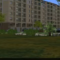 Modern Residential Building Exterior With Yellow Facade Multiple Windows And Green Landscaping Surrounded By Trees