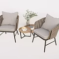 Wicker Chair and Table Set with Gray Cushions Small Round Table Green Plant and Books