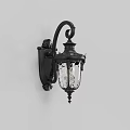 Classic Black Metal Wall Light With Ornate Carved Design Glass Shade Illuminated On White Wall