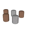 Five Round Brown and Gray Stools on Marble Floor Against Light Wall
