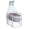 Cozy White Baby Crib with Curved Rails and Pink Purple Quilts Plus White Canopy