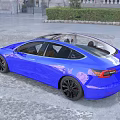 Blue Modern Sedan with Sleek Design and Black Wheels on Urban Cobblestone Street