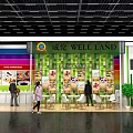 WELL LAND Exhibition Booth Featuring Colorful Striped Walls Green Pillars And Food Display With Visitors