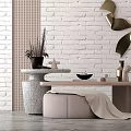 Modern Minimalist Side Table With Stool And Decorative Items Against White Brick Wall 3d model