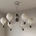 Modern Minimalist Chandelier With White Spherical Shades Metal Frame And Decorative Black Accents