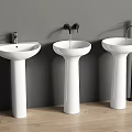 White Pedestal Washbasins with Different Faucets Against Gray Wall on Wooden Floor