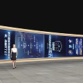 A Woman Standing in Front of Large Digital Display With Icons and Information Text