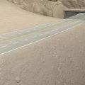 Scenic Desert Highway Leading To Tunnel Through Rocky Cliffs And Sand Dunes