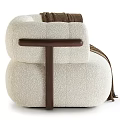 Cream Colored Textured Fabric Armchair With Dark Brown Wooden Armrest And Brown Fringe Blanket