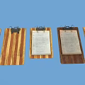 Three Wooden Clipboards With Metal Clips And Papers On Blue Background