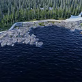 Tranquil Park Landscape With Calm Lake Rocky Shore And Lush Forest Trails