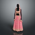 Man In Pink Traditional Attire With Gold Embroidery Standing Against Gray Background