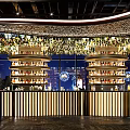 MOII Bar Interior With Black Brick Walls White Sculptures And Wavy Ceiling