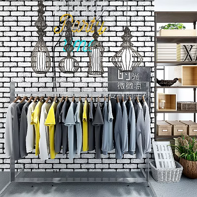 Stylish Casual Clothes Hanging On Racks Against Brick Wall With Lantern Decorations And Green Plants 3d model