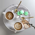 White Latte Art Coffee Cups On Tray With Green Star Cookies Sugar Cubes Golden Spoons
