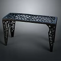 Elegant black metal bench with intricate cutout patterns and carved decorative legs