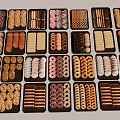 Assorted Decorated Cookies Displayed In Multiple Trays With Various Shapes And Designs