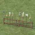 Various Shaped Weapons Displayed On Wooden Racks In Grass Field