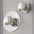 Elegant Modern Wall Sconces Mounted on Wall with Silver Gold Accents and Round Mirror