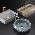 Three Modern Stone Washbasins in Different Shapes with Golden and Silver Faucets