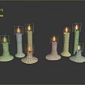 Elegant Lit Candles of Various Heights on Black Surface with Reflections