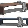 Brown And Blue Upholstered Ottoman With Black And White Checkered Blanket
