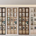 Modern Multiple Bookcases With Glass Doors And Open Shelves Holding Books Decorative Items