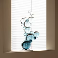 Decorative Blue Transparent Spheres Sculpture Placed By Window With White Blinds