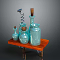 Light Blue Glass Bottles Of Various Sizes On Wooden Tray With Corkscrew