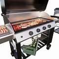 Outdoor Grill Setup With Sausages Meat Skewers Plates And Bottles